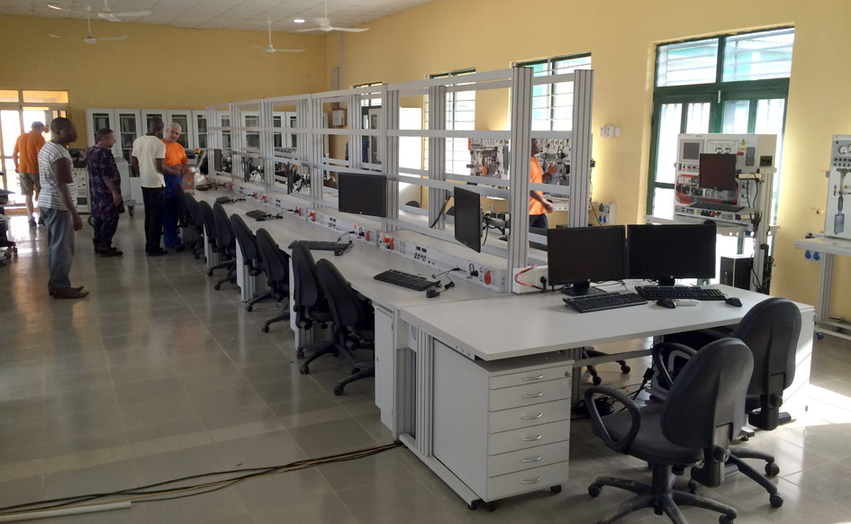 Students in a modern automotive training workshop using diagnostic equipment
